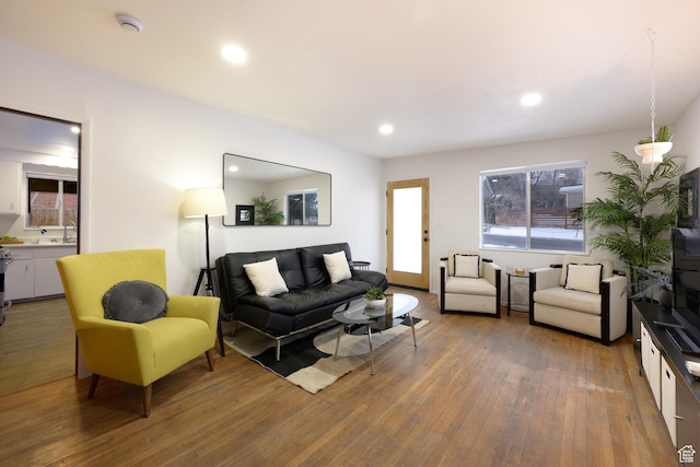 living room featuring a wealth of natural light, recessed lighting, and wood finished floors
