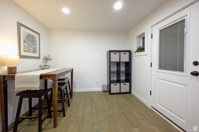 dining room featuring baseboards, recessed lighting, and wood finished floors