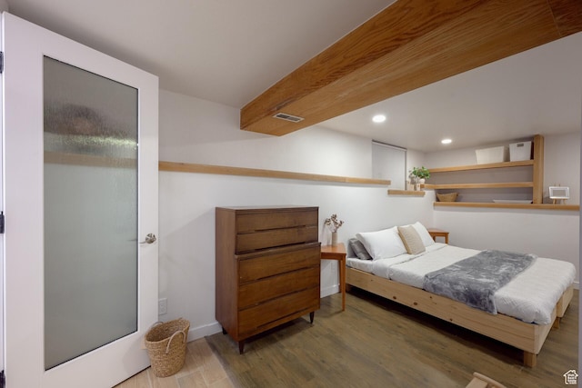 bedroom featuring visible vents, baseboards, recessed lighting, and wood finished floors