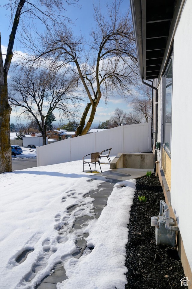 snowy yard with fence