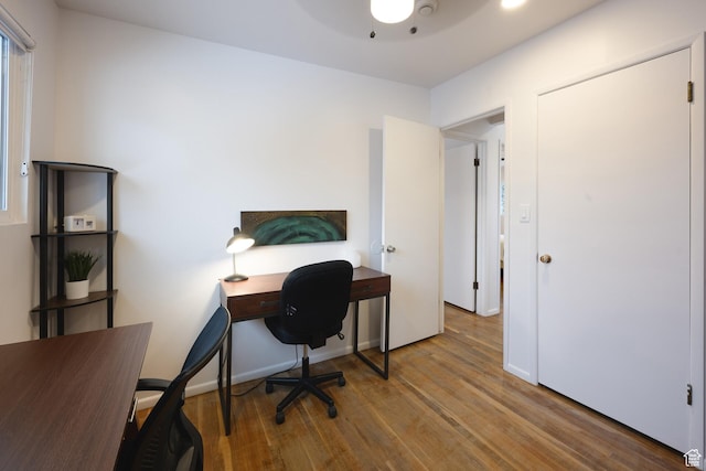 home office featuring a ceiling fan and wood finished floors