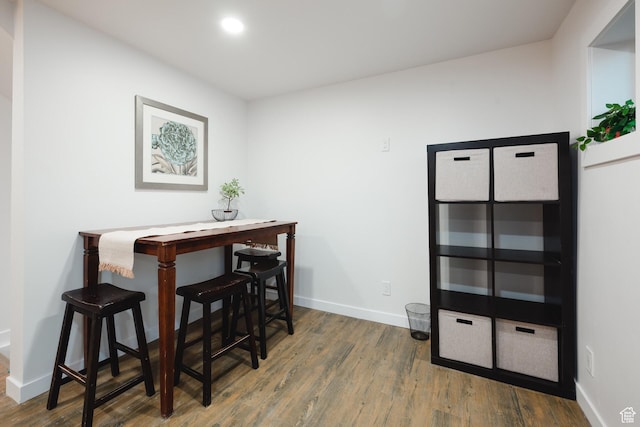 dining room featuring wood finished floors, baseboards, and recessed lighting