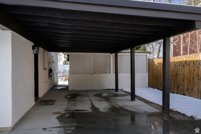 view of patio / terrace featuring a carport and fence