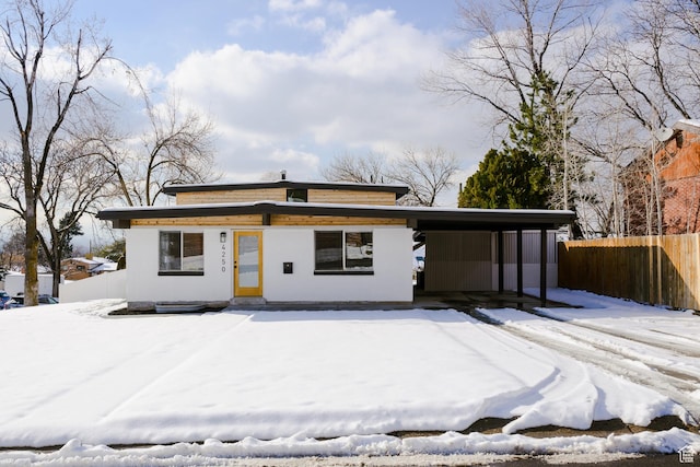 view of front of home featuring fence and an attached carport