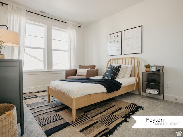bedroom with baseboards, visible vents, and carpet