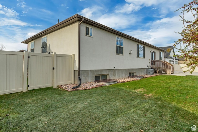 1184 W Michaelsen, West Jordan, UT 84088 - view of property exterior with central AC, a yard, fence, stucco siding, and a gate
