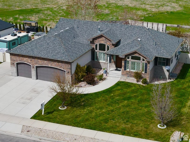 1184 W Michaelsen, West Jordan, UT 84088 - view of front of property featuring an attached garage, stone siding, a front lawn, and concrete driveway
