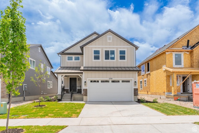3759 W 950 N Unit 376, Lehi, UT 84043 - craftsman-style house with board and batten siding, a standing seam roof, an attached garage, concrete driveway, and a front yard
