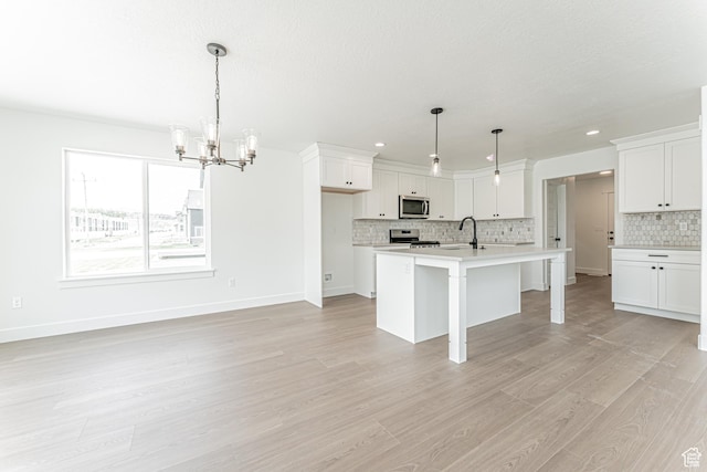 3759 W 950 N Unit 376, Lehi, UT 84043 - kitchen featuring stainless steel appliances, a chandelier, tasteful backsplash, light wood finished floors, and light countertops