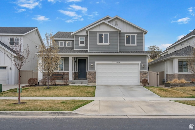 15097 S Cantle Dr, Bluffdale, UT 84065 - craftsman house with board and batten siding, concrete driveway, a garage, a gate, and stone siding