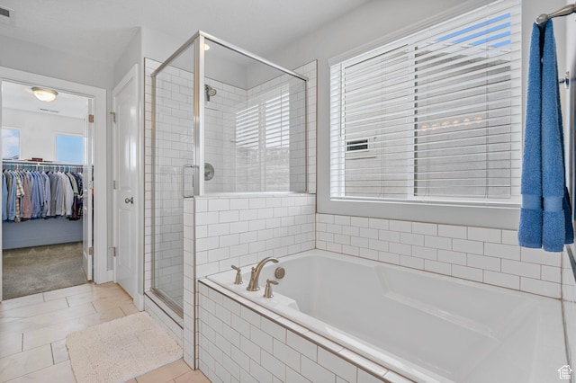 15097 S Cantle Dr, Bluffdale, UT 84065 - bathroom with a shower stall, a garden tub, a walk in closet, and tile patterned floors
