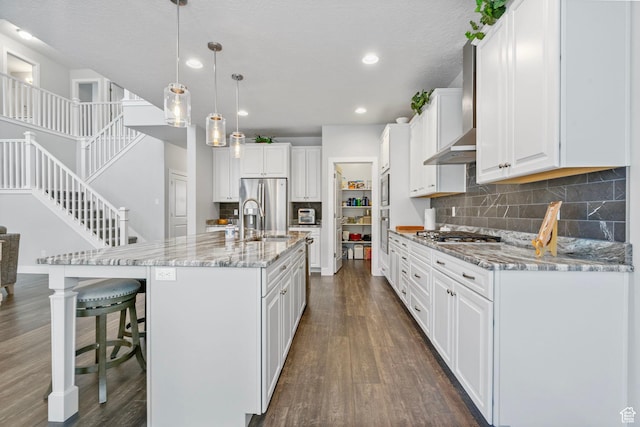 15097 S Cantle Dr, Bluffdale, UT 84065 - kitchen with a sink, dark wood-style flooring, wall chimney range hood, white cabinets, and recessed lighting