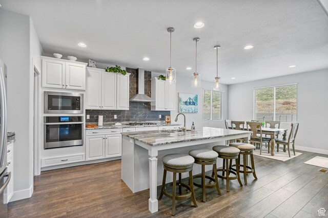 15097 S Cantle Dr, Bluffdale, UT 84065 - kitchen with appliances with stainless steel finishes, wall chimney range hood, dark wood-type flooring, backsplash, and recessed lighting