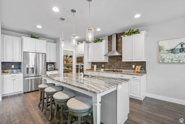 15097 S Cantle Dr, Bluffdale, UT 84065 - kitchen featuring appliances with stainless steel finishes, wall chimney exhaust hood, tasteful backsplash, dark wood-style floors, and a sink