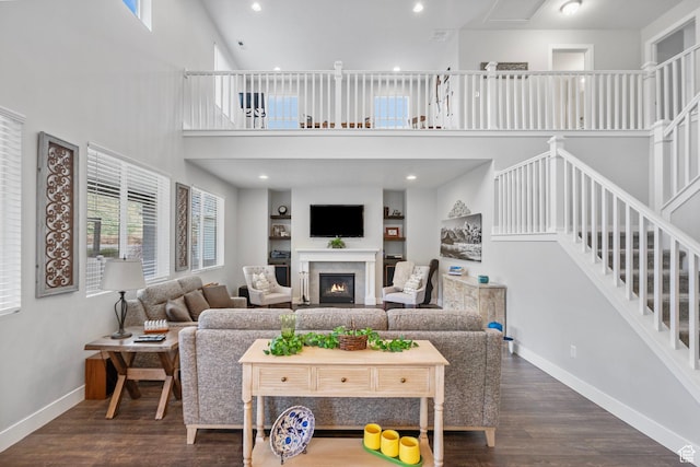 15097 S Cantle Dr, Bluffdale, UT 84065 - living area with a high ceiling, baseboards, a lit fireplace, wood finished floors, and stairway