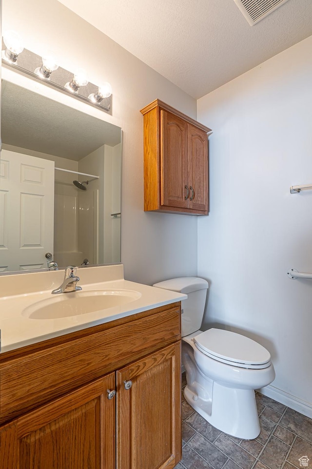 275 W 260 N, Hyde Park, UT 84318 - bathroom featuring a shower, vanity, toilet, a textured ceiling, and visible vents