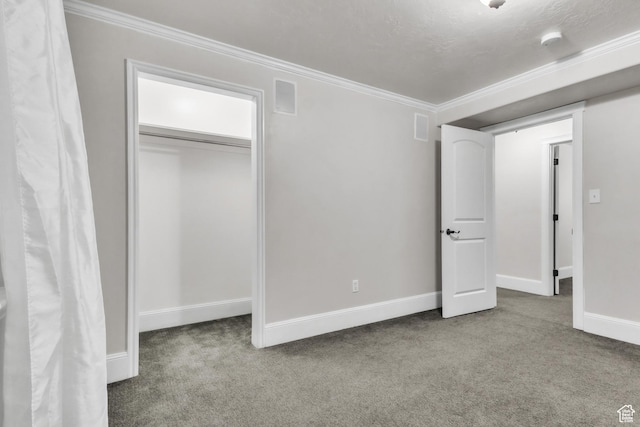unfurnished bedroom with baseboards, crown molding, and carpet floors