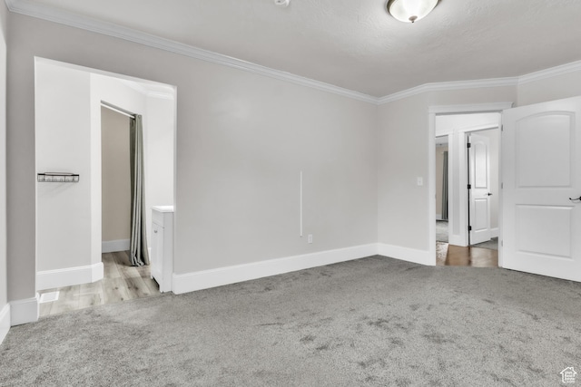 unfurnished bedroom featuring carpet floors, ornamental molding, and baseboards
