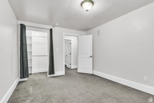 unfurnished bedroom with baseboards and carpet
