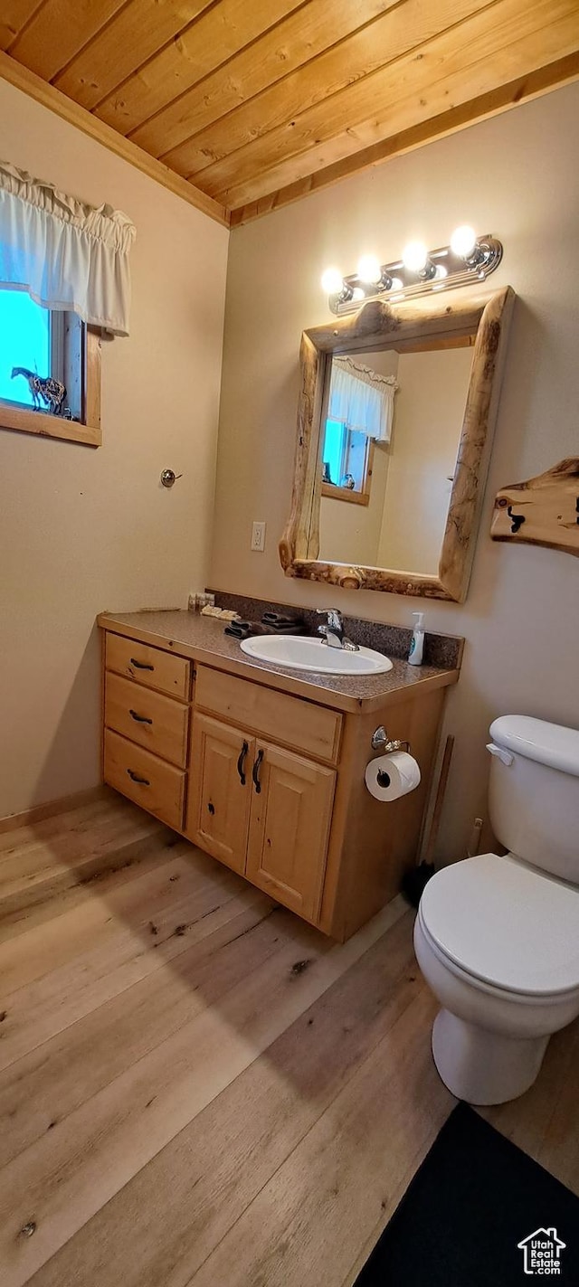 3526 Browning Rd, Island Park, ID 83429 - half bath with toilet, wood ceiling, vanity, and wood finished floors