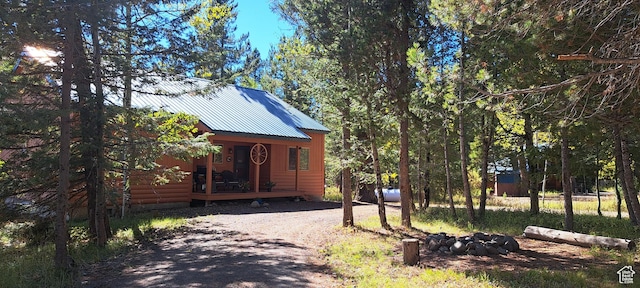 3526 Browning Rd, Island Park, ID 83429 - view of front facade featuring driveway and metal roof