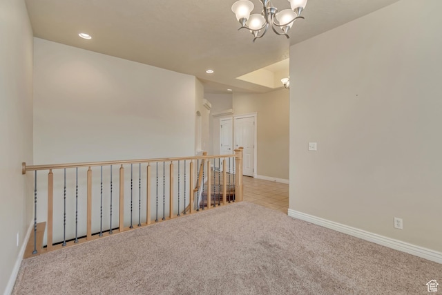 carpeted empty room with tile patterned floors, a notable chandelier, baseboards, and recessed lighting