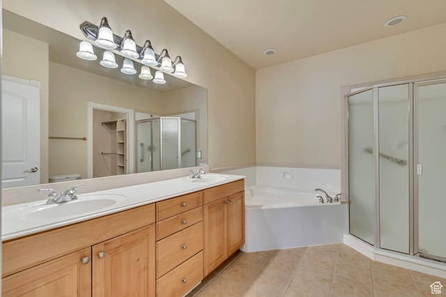 bathroom with tile patterned floors, a sink, a stall shower, and a bath