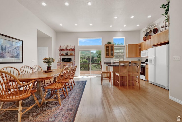 3674 N Willow Brooke Ln, Eden, UT 84310 - dining room featuring light wood-type flooring, a high ceiling, recessed lighting, and a fireplace