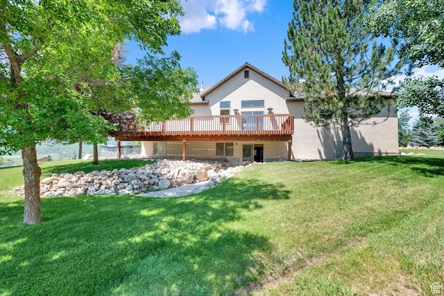 3674 N Willow Brooke Ln, Eden, UT 84310 - rear view of house with stucco siding, a deck, a garage, and a yard