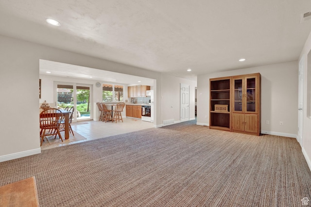 3674 N Willow Brooke Ln, Eden, UT 84310 - unfurnished living room featuring light carpet, baseboards, visible vents, and recessed lighting