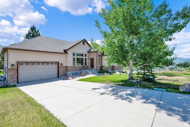 3674 N Willow Brooke Ln, Eden, UT 84310 - view of front of property with a front lawn, concrete driveway, stucco siding, and an attached garage