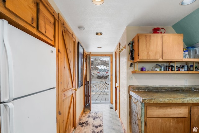 2586 S Red Willow Ln Unit 607, Heber City, UT 84032 - kitchen featuring open shelves, a textured ceiling, dark countertops, freestanding refrigerator, and light floors