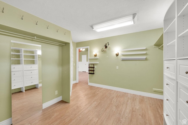 spacious closet featuring light wood-style floors