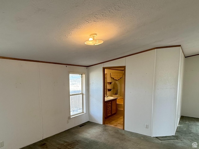 2445 N 260 W, Elmo, UT 84521 - unfurnished bedroom featuring a textured ceiling, visible vents, carpet, ornamental molding, and connected bathroom