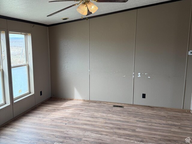 2445 N 260 W, Elmo, UT 84521 - unfurnished room with a textured ceiling, light wood-type flooring, visible vents, and a ceiling fan