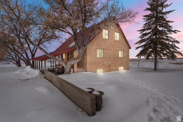 377 E Shore Rd, Saint Charles, ID 83272 - view of snow covered exterior with brick siding