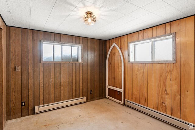 377 E Shore Rd, Saint Charles, ID 83272 - spare room with plenty of natural light, baseboard heating, and wood walls