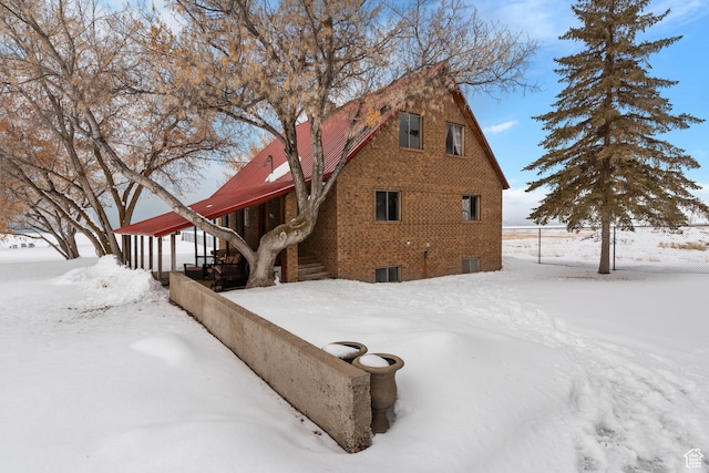 377 E Shore Rd, Saint Charles, ID 83272 - snow covered property featuring brick siding