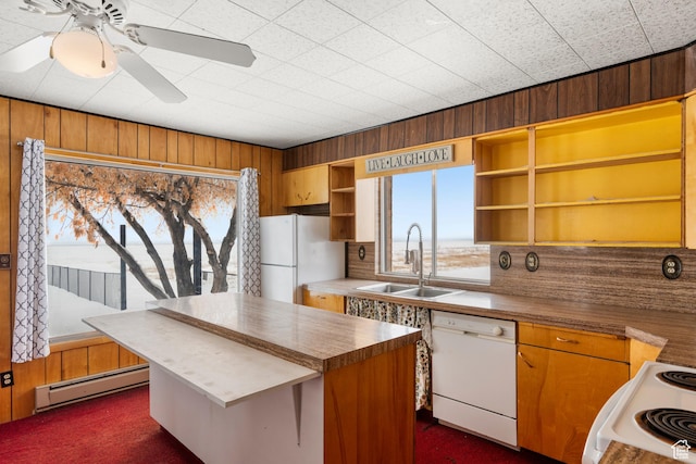 377 E Shore Rd, Saint Charles, ID 83272 - kitchen featuring a sink, open shelves, a baseboard radiator, white appliances, and a healthy amount of sunlight