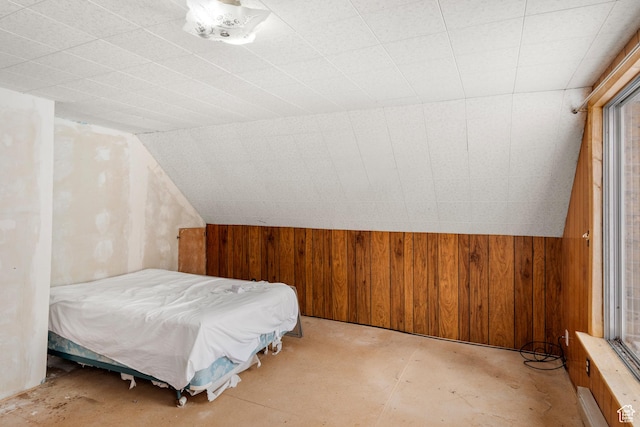 377 E Shore Rd, Saint Charles, ID 83272 - bedroom featuring unfinished concrete floors, wood walls, and lofted ceiling