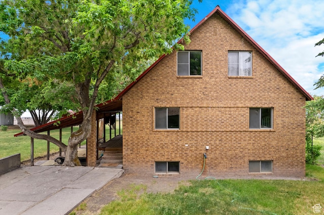 377 E Shore Rd, Saint Charles, ID 83272 - view of side of property with brick siding and a yard