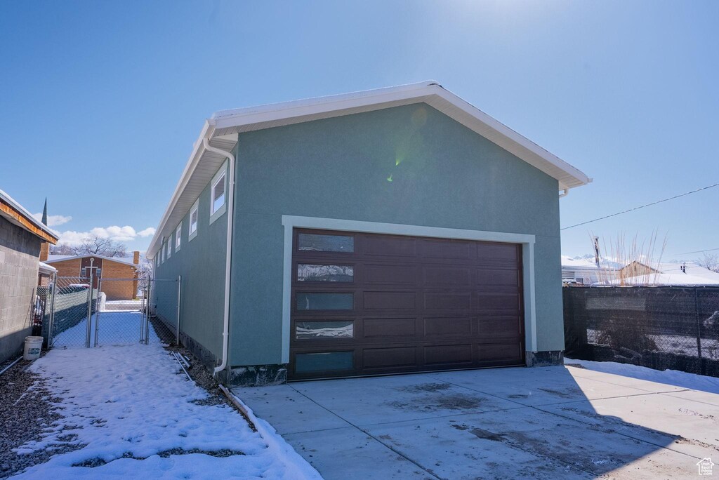 565 N 1200 W, Salt Lake City, UT 84116 - snow covered garage with fence, a gate, and a detached garage