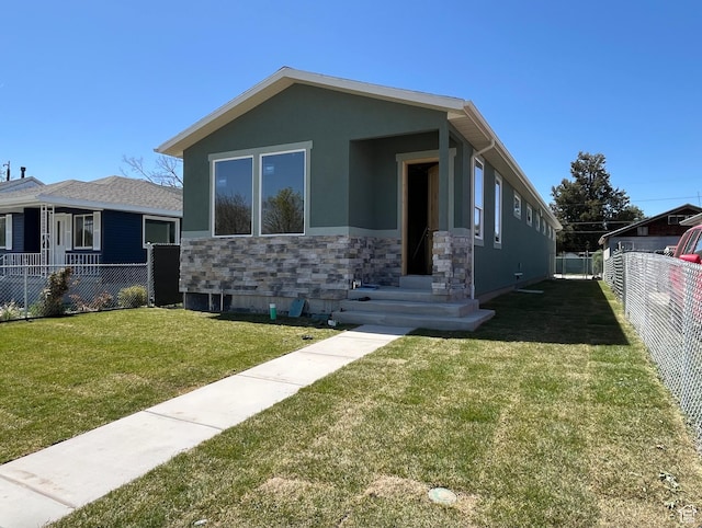 565 N 1200 W, Salt Lake City, UT 84116 - view of front of home with a front lawn, fence, stone siding, and stucco siding