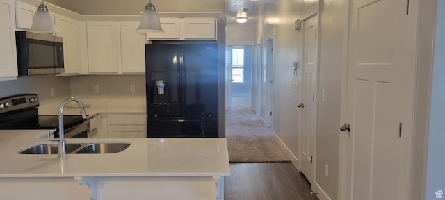13091 S Newbridge Ln Unit F202, Herriman, UT 84096 - kitchen featuring light countertops, dark wood-style flooring, stainless steel appliances, hanging light fixtures, and white cabinets