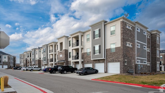 13091 S Newbridge Ln Unit F202, Herriman, UT 84096 - view of property featuring a residential view and an attached garage