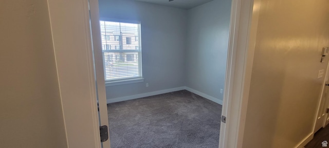13091 S Newbridge Ln Unit F202, Herriman, UT 84096 - unfurnished room with baseboards, a wealth of natural light, and dark colored carpet