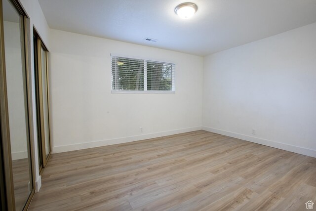 3510 S 300 E Unit E, South Salt Lake, UT 84115 - unfurnished bedroom featuring light wood finished floors, a closet, and baseboards
