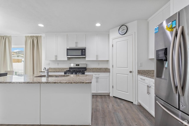 3414 S Melanie Cv W Unit 13, Magna, UT 84044 - kitchen featuring white cabinets, a sink, light stone countertops, and appliances with stainless steel finishes