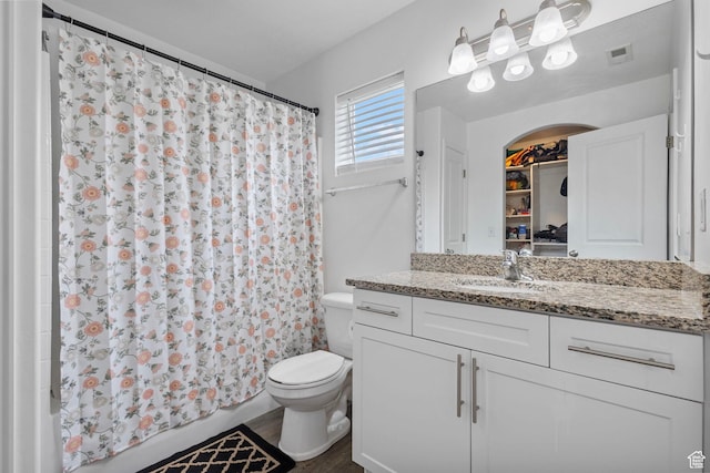 3414 S Melanie Cv W Unit 13, Magna, UT 84044 - full bathroom with visible vents, toilet, vanity, and shower / bathtub combination with curtain