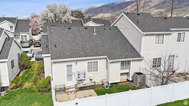 499 N 200 W Unit 8, Bountiful, UT 84010 - back of house featuring central air condition unit, fence, a shingled roof, entry steps, and a mountain view